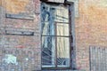 One old window with an iron grate on a brown brick wall Royalty Free Stock Photo