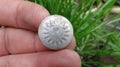 One old worn gray white aluminum button Royalty Free Stock Photo