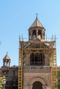 Armenia, Echmiadzin, September 2021. Yellow scaffolding around the bell tower of the old cathedral.