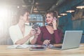 One-on-one meeting.Two young business women are sitting in office at table and working together. Royalty Free Stock Photo
