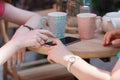 One-on-one meeting. Two young women sitting at table in cafe. Girl shows her friend image on screen of smartphone Royalty Free Stock Photo