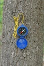 one open blue plastic compass hangs on a yellow cord Royalty Free Stock Photo