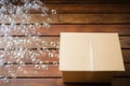 One open cardboard box with bubble wrap on wooden. Generate Ai Royalty Free Stock Photo