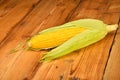 One open corn cob on vintage wooden surface Royalty Free Stock Photo