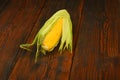 One open corn cob on vintage wooden surface Royalty Free Stock Photo