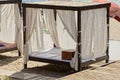 One open gazebo with curtains pillow and bedding on the sand