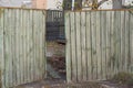 one open old wooden gray green gate on a rural street Royalty Free Stock Photo