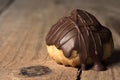 One open traditional type of Brazilian profiterolis bakery candy called carolina in rustic wood background
