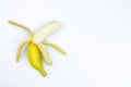 One opened banana on a white background