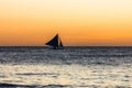 One outrigger sailboat on the horizon Royalty Free Stock Photo