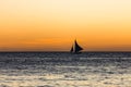 One outrigger sailboat on the horizon Royalty Free Stock Photo