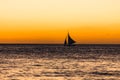 One outrigger sailboat on the horizon Royalty Free Stock Photo