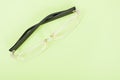 One pair of sight glasses on green background