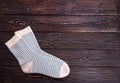 One pair white socks with light blue strip on a wooden background