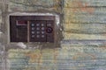 Panel management of the old on-door speakerphone on a concrete wall Royalty Free Stock Photo