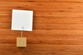 One paper note with holder on bamboo wooden background Royalty Free Stock Photo