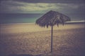 One parasol on lonely beauty beach. Tropical atmosphere with single umbrella. Vintage old photograph