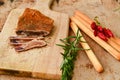 One partly cut piece and slices of cured pork and parmesan cheese Royalty Free Stock Photo