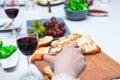 One of partying girls clinking flutes with sparkling wine. Girls hand with rings hold a glass of red wine Royalty Free Stock Photo