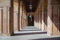 One of the passages surrounding the courtyard of the Mosque of Ahmad Ibn Tulun framed by huge decorated arches, Cairo, Egypt