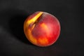 One peach on black Royalty Free Stock Photo
