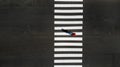 One pedestrian crossing zebra crosswalk, aerial, top view. Royalty Free Stock Photo