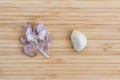 one peeled clove of garlic and peeling Royalty Free Stock Photo