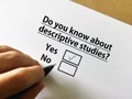 Questionnaire. One person is answering question about research. The person knows about descriptive studies