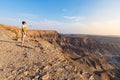 One person looking at the Fish River Canyon, scenic travel destination in Southern Namibia. Expansive view at sunset. Wanderlust t Royalty Free Stock Photo