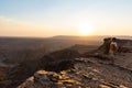 One person looking at the Fish River Canyon, scenic travel destination in Southern Namibia. Expansive view at sunset. Wanderlust t Royalty Free Stock Photo