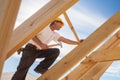 Roofer,builder working on roof structure of building on construction site