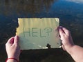 One person reading help message on a crystal bottle Royalty Free Stock Photo