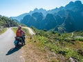 One person riding bike on Ha Giang motorbike loop, famous travel destination bikers easy riders. Ha Giang karst geopark mountain