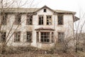 One photo of an old and terrible abandoned farmhouse, which eventually deteriorates, overgrown with old trees. Here lived an old m Royalty Free Stock Photo