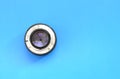 One photographic lense lie on a bright blue background. Space fo Royalty Free Stock Photo