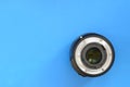 One photographic lense lie on a bright blue background. Space fo Royalty Free Stock Photo