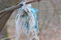 one piece of blue white dirty old cellophane hanging tied in a knot Royalty Free Stock Photo