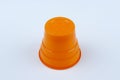 One piece orange plastic cup on white background Royalty Free Stock Photo