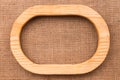 One-piece oval wooden frame lying on burlap. Royalty Free Stock Photo