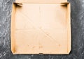 One piece of pizza in cardboard pizza box Top view of empty box with copy space on dark concrete