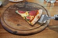One Piece of Pizza Left on Wooden Tray