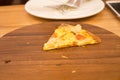 One piece of pizza on wooden plate pizza Royalty Free Stock Photo