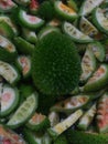 One piece spiny gourd with sliced pieces of the same.