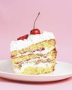 One piece of vanilla cherry cake on a white plate over pastel pink background. Delicious sweet dessert close up. Royalty Free Stock Photo