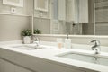 One-piece washbasin with two sinks and two taps in a bathroom