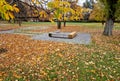 one piece of wood made prism park bench painted brown footsteps Royalty Free Stock Photo