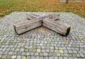 one piece of wood made prism park bench painted brown footsteps Royalty Free Stock Photo