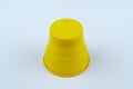 One piece yellow plastic cup on white background