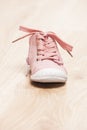 one pink baby shoe on the floor Royalty Free Stock Photo