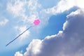 One pink kite flying over a cloudy sky Royalty Free Stock Photo